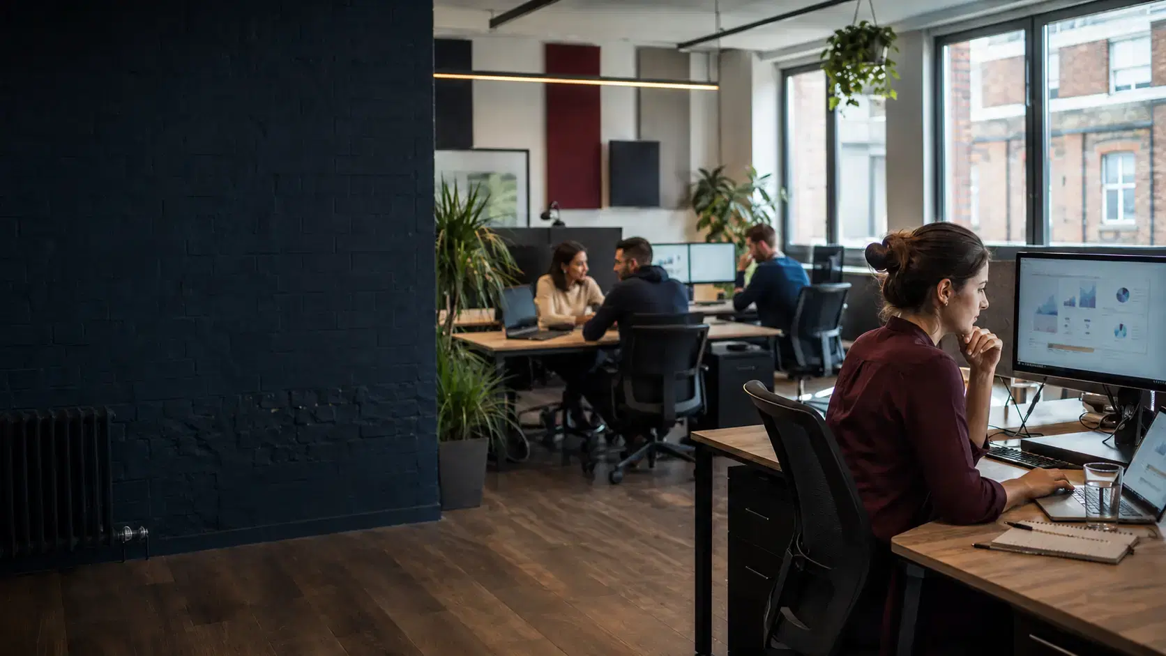 Data professional working with operational dashboards in a contemporary London office.